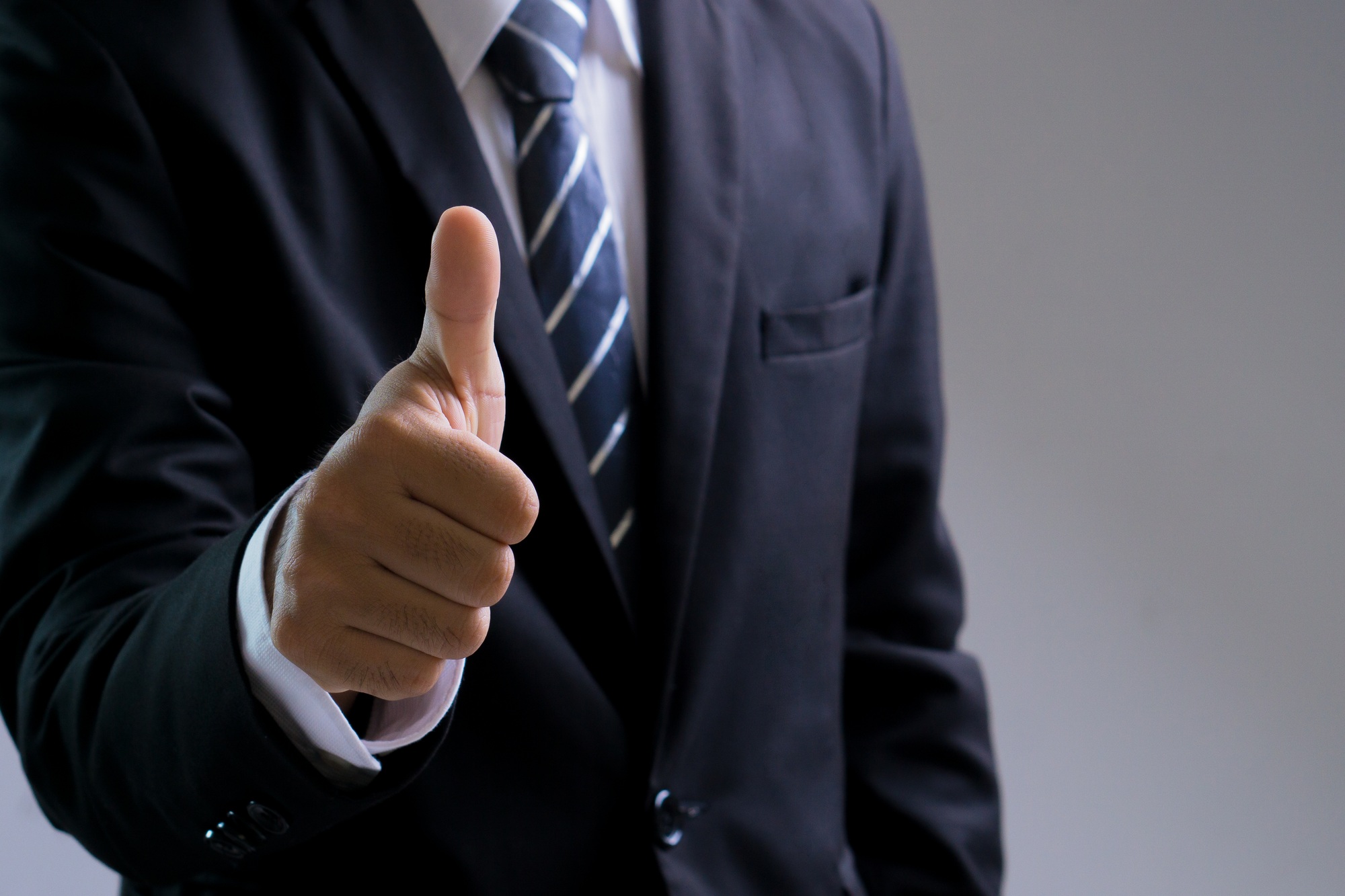 Businessman hand showing thumb up.The excellence of the business or service concept.