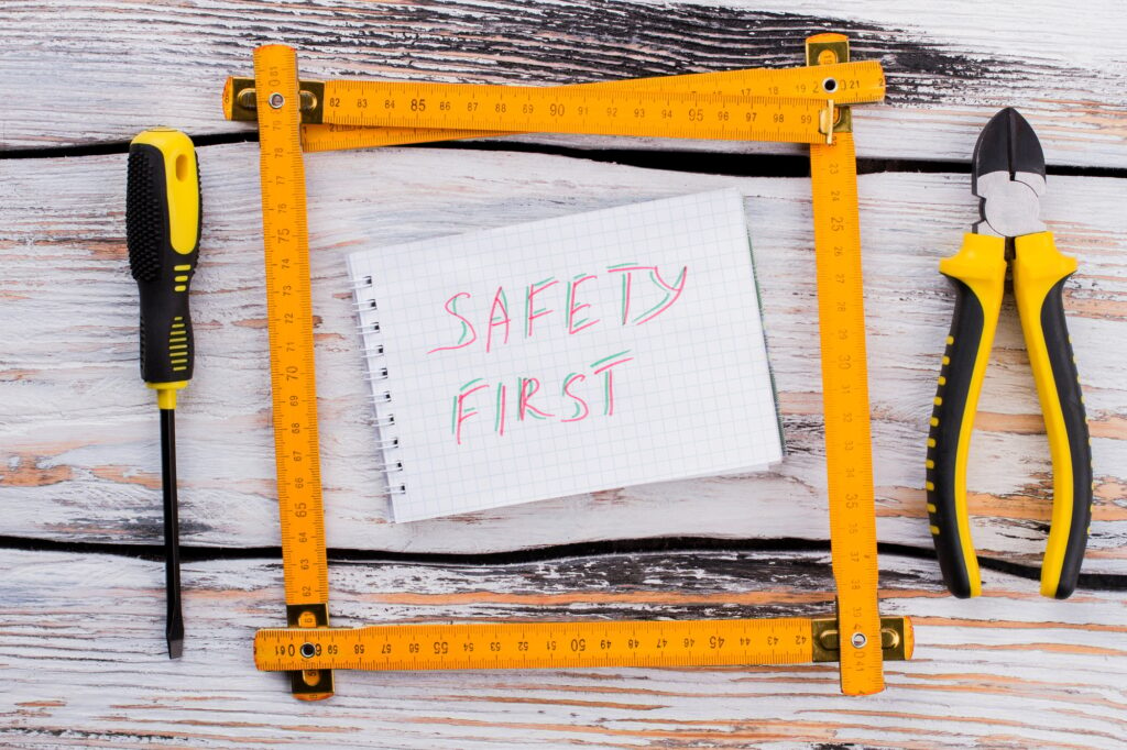 Safety first note in a frame made of an angle ruler.